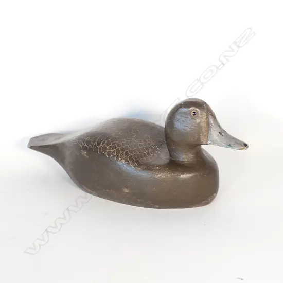 A carved and painted wooden duck decoy