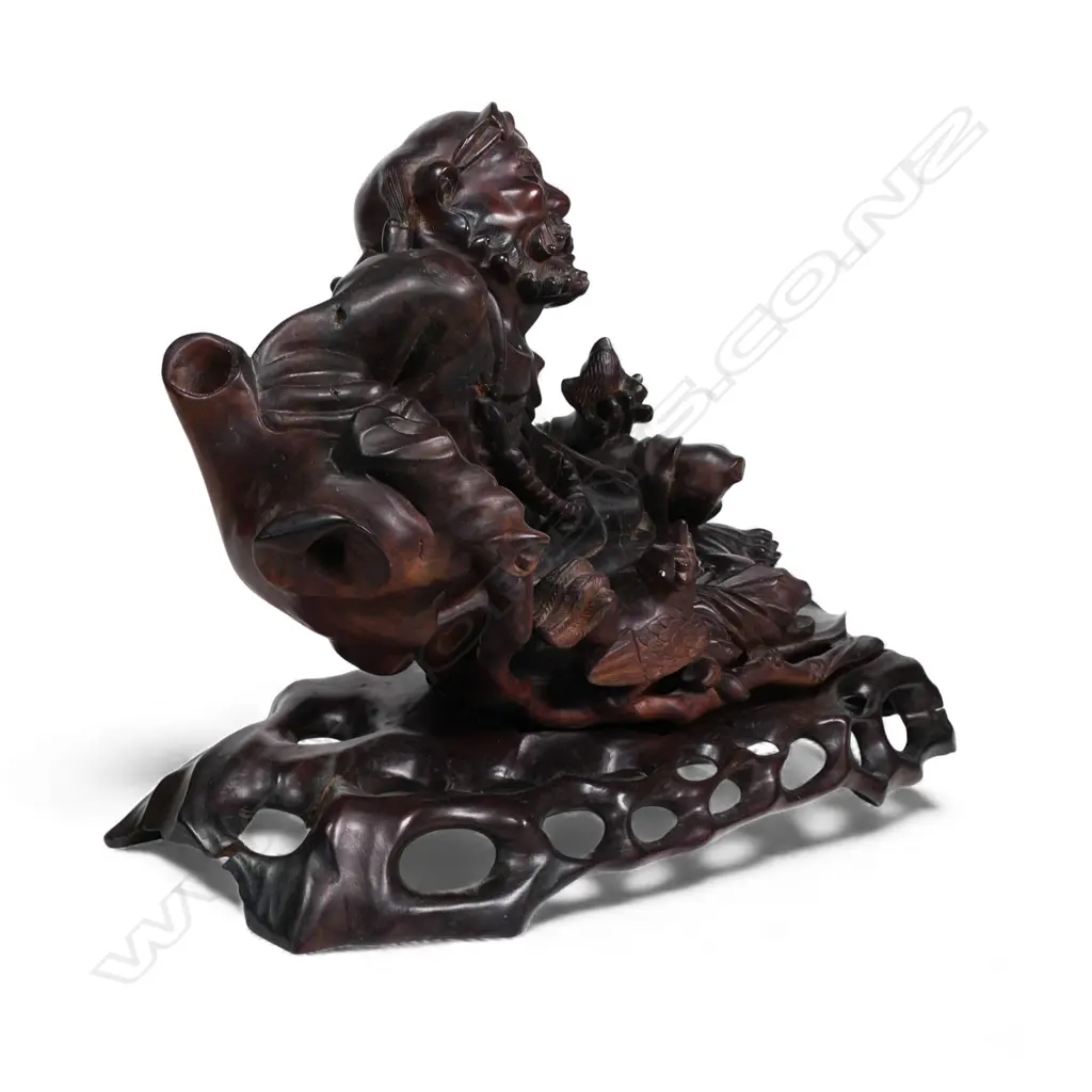 A carved Chinese hardwood reclining Immortal, Image 1++