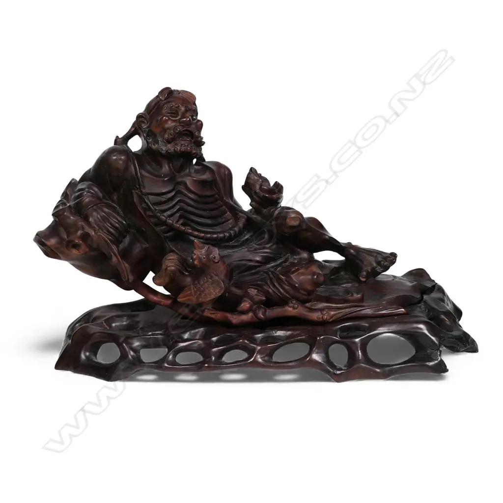 A carved Chinese hardwood reclining Immortal, Image 1++