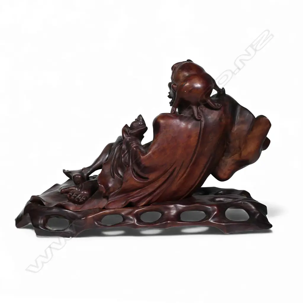 A carved Chinese hardwood reclining Immortal, Image 1++