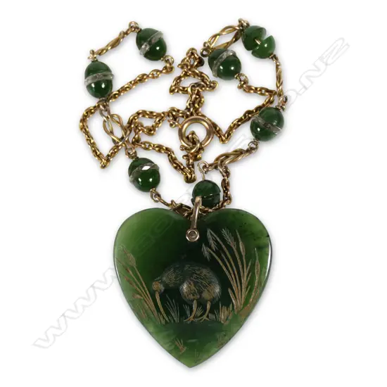 A c.1900 engraved pounamu heart pendant on chain with pounamu links,