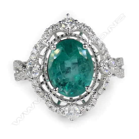 A 14ct white gold emerald and diamond ring,