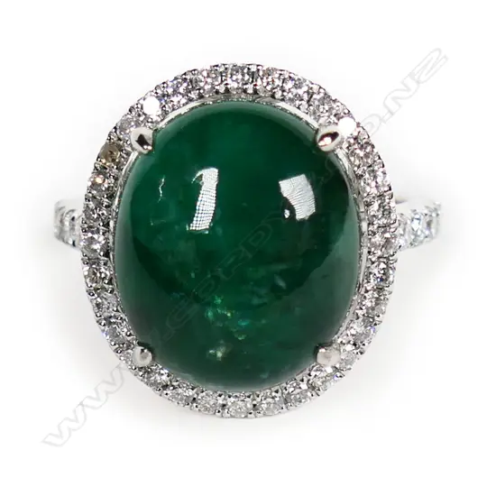 An 18ct white gold diamond and emerald ring,
