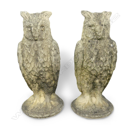 A pair of classical Church Stone owl garden ornaments, standing on circular bases. H.670mm.
