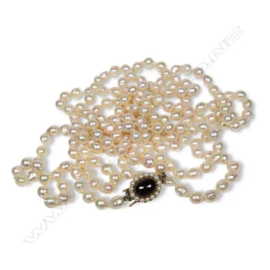An opera length (70") semi baroque pearl necklace,
