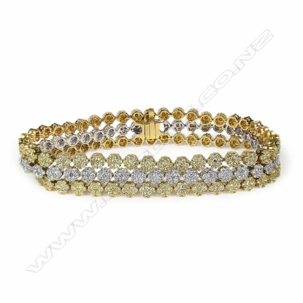 An 18ct white gold white and yellow diamond three strand bracelet, Image 1++