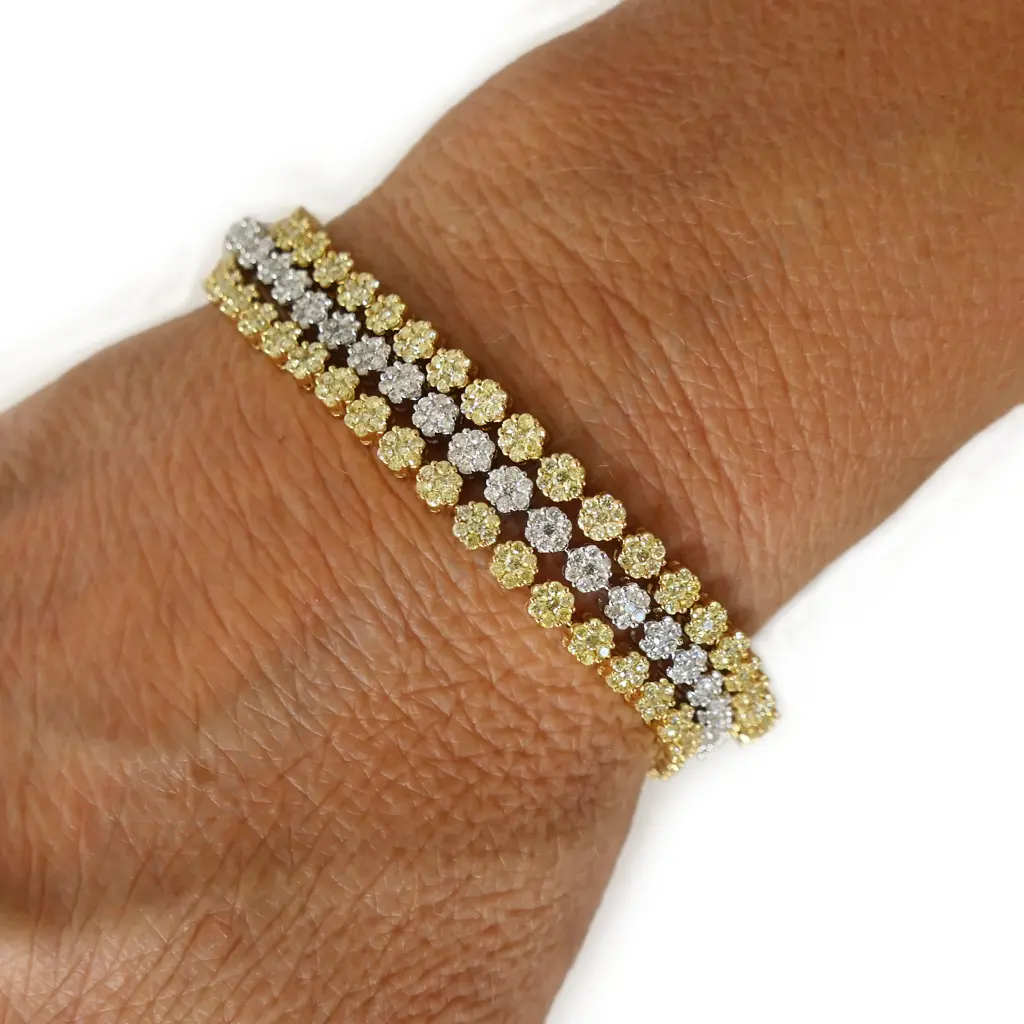 An 18ct white gold white and yellow diamond three strand bracelet, Image 1++