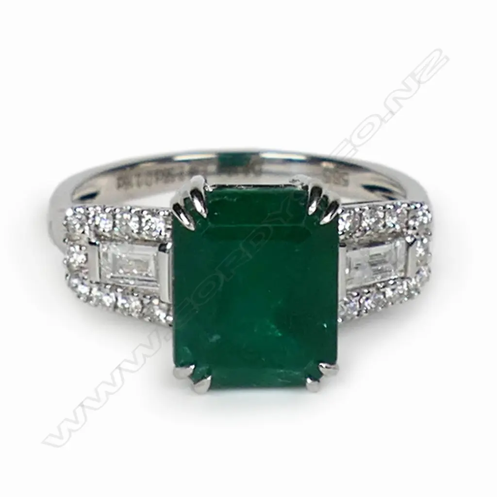 A 14ct white gold emerald and diamond dress ring, Image 1++