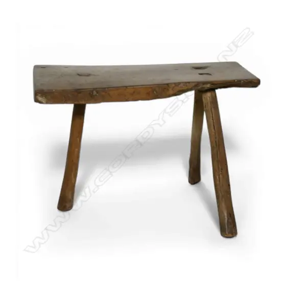 A George III or earlier primitive three leg fruitwood stool,