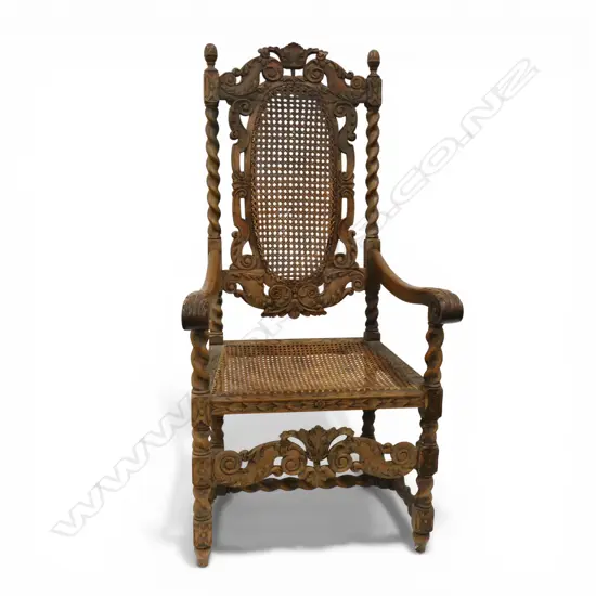 A late 19thC Jacobean style carved oak carver armchair,