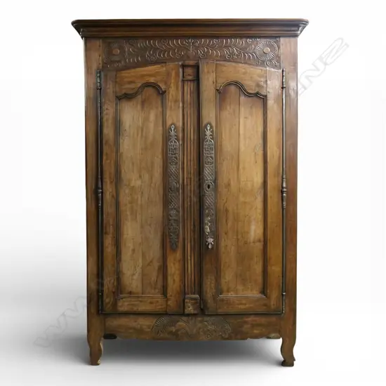 An early 19thC French walnut armoire,