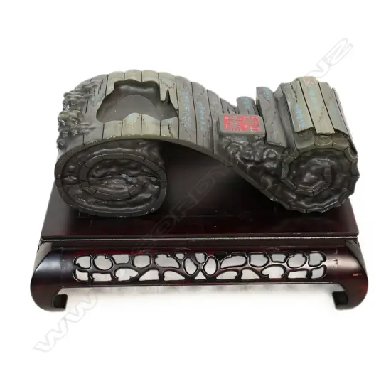 A Chinese finely carved grey marble scrolling form,