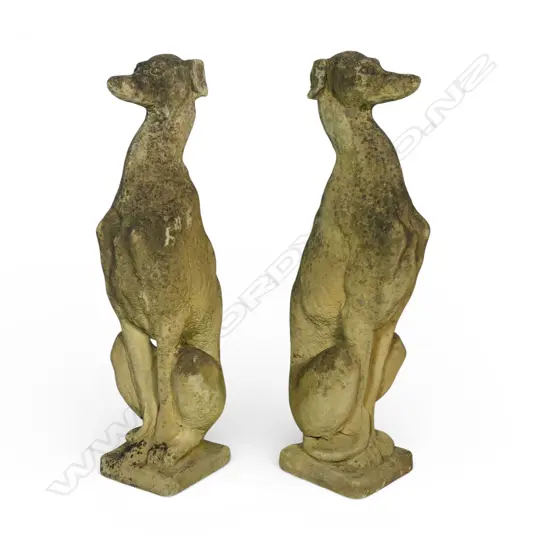 A pair of classical Church Stone greyhounds, in seated position, on small plinth base, weathered patina. H.750mm.