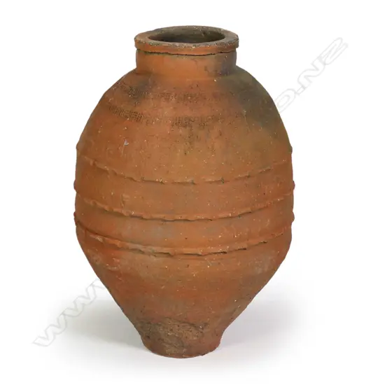 An old European terracotta tall olive oil storage jar