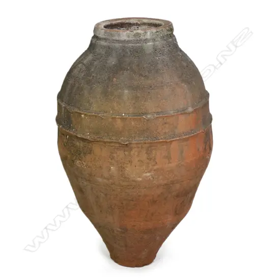 An old European terracotta tall olive oil storage jar