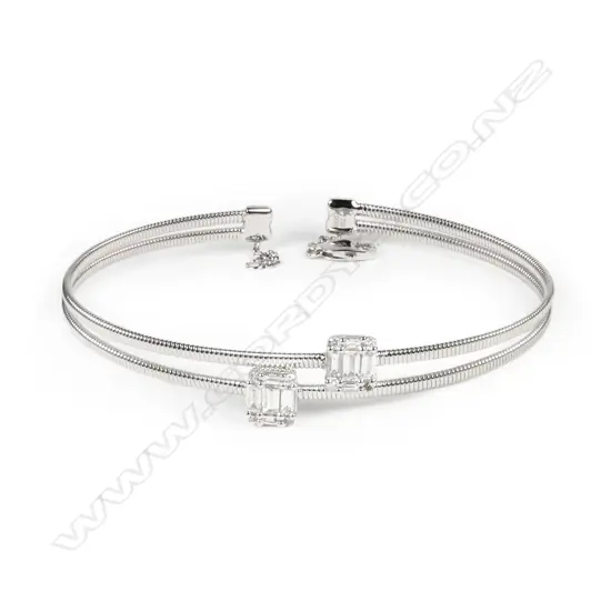 An 18ct white gold and diamond sprung bangle
