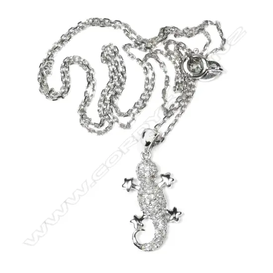 A 9ct white gold and diamond lizard pendant