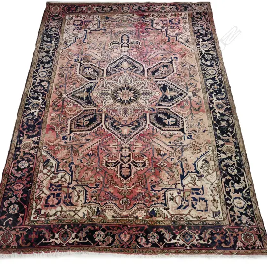 An old Persian Heriz hand knotted carpet