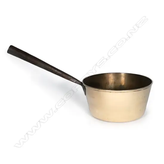 A large heavy brass saucepan