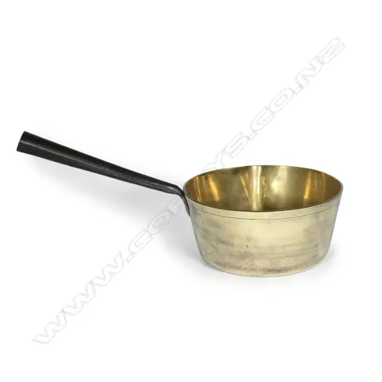 A heavy brass saucepan