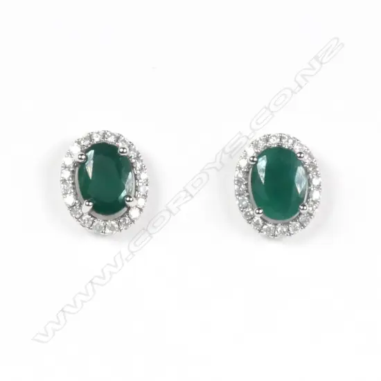 A pair of 14ct white gold emerald and diamond halo stud earrings