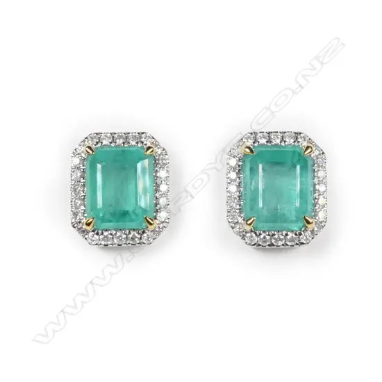 A pair of 14ct white gold Columbian emerald and diamond halo stud earrings