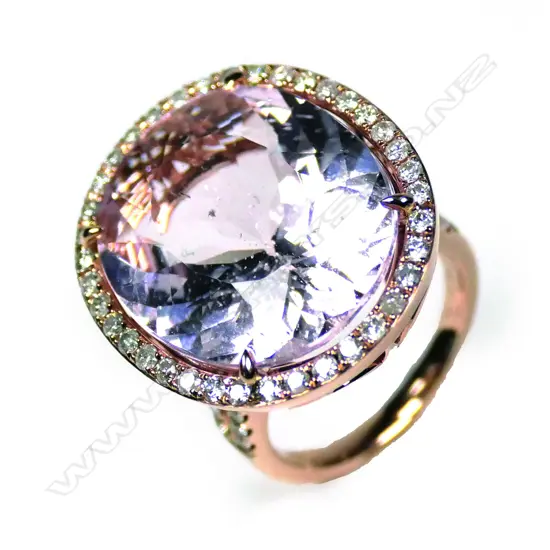 A 14ct rose gold kunzite and diamond halo ring