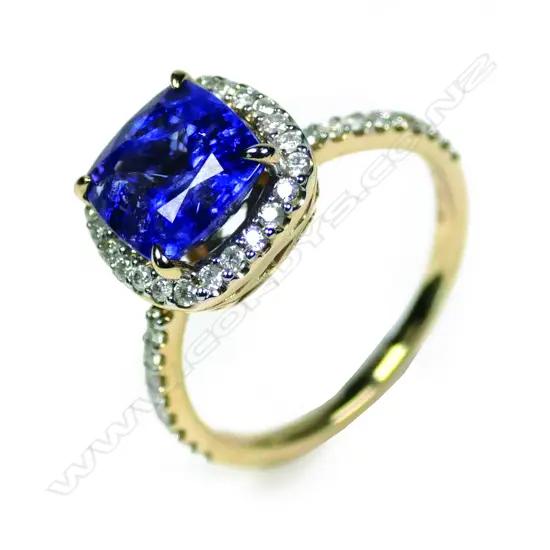A 14ct yellow gold tanzanite and diamond halo ring