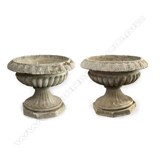 A pair of decorative concrete garden urns