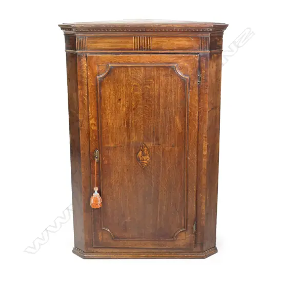 A Georgian oak corner cabinet