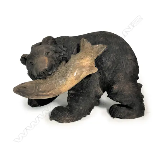 A large mid 20thC carved wood Hokkaido kibori kuma hunting bear and salmon sculpture