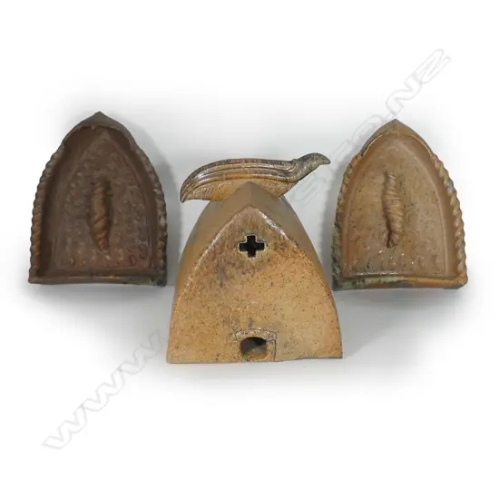Mike O'Donnell (Taraiki Pottery) 'House of Manu', salt glazed stoneware three-piece sculpture, the 'House' with stylised bird form to the roof apex, inscribed roof, the end with pierced cross and lower opening with koru impressed decoration, the two flanking doorway forms with stylised open winged birds to the top, each incorporating a large sculpted volute scroll on repeating shell impressed textured ground, heavy salt glazed effects in part. The house 330 x 340 x 355mm, the doorway's H.420mm.