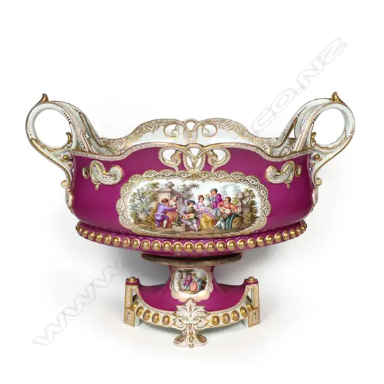 A 19thC KPM flower trough, pierced and gilded embellishment to the rim and base, scrolling side handles, the front with Angelica Kauffmann style garden scenes, the back decorated with wildflowers, on deep pink/puce ground.  370 x 200 x 280mm.