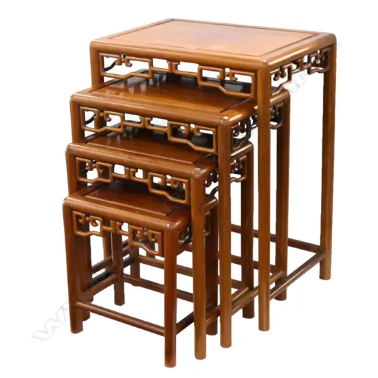A Chinese rosewood nest of tables, the four stacking tables with decorative aprons.  500 x 350 x 660mm (largest).