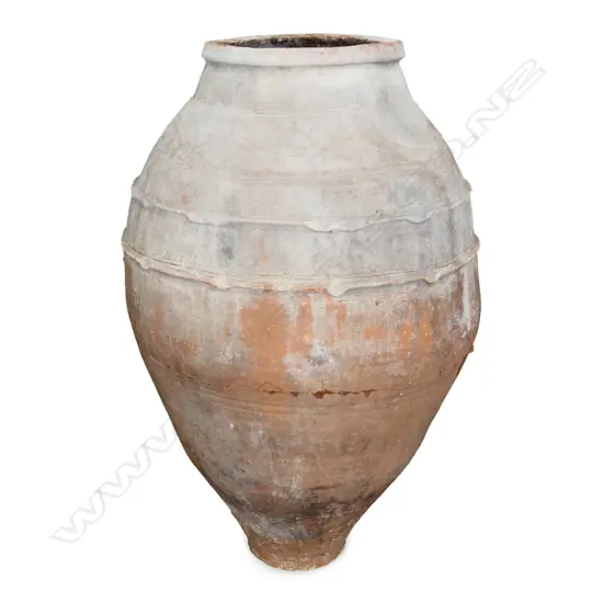 An old European terracotta tall olive oil storage jar