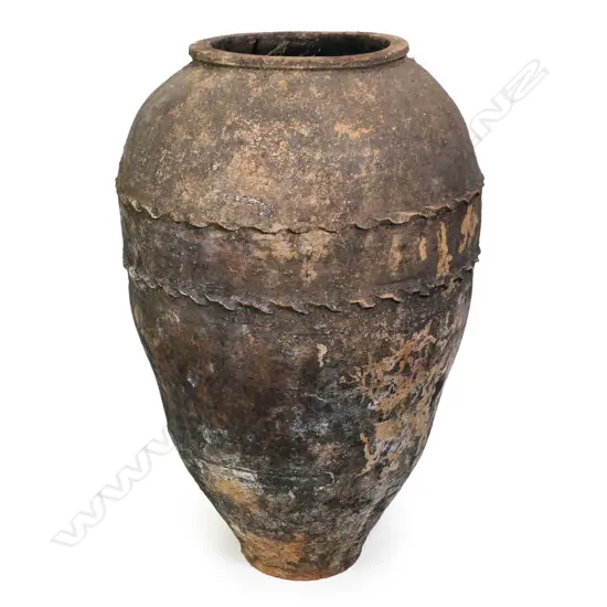 An old European terracotta tall olive oil storage jar,