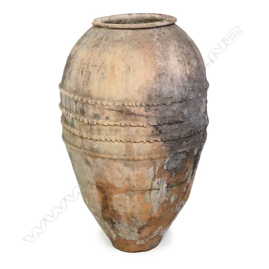 An old European terracotta tall olive oil storage jar,