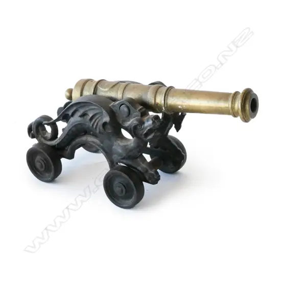 A small brass and iron replica cannon,