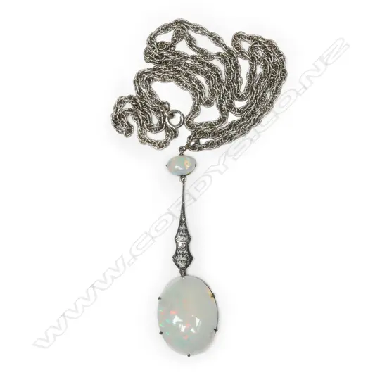 A stylish early 20thC silver and large opal pendant on chain,