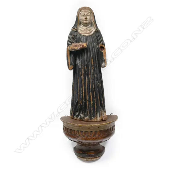 A 19thC wood figure of a nun,