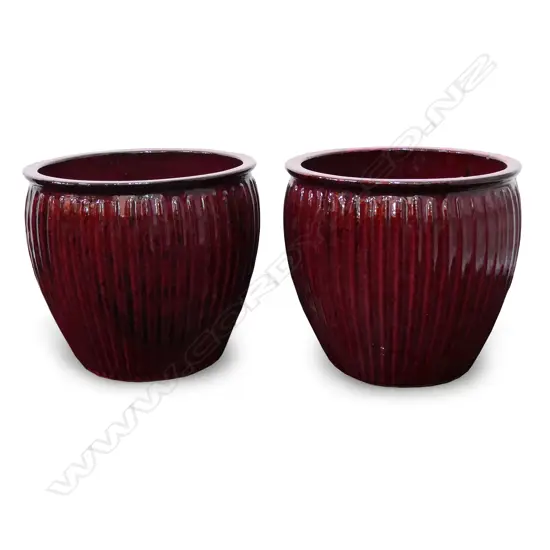 A pair of large dark red glazed garden pots,