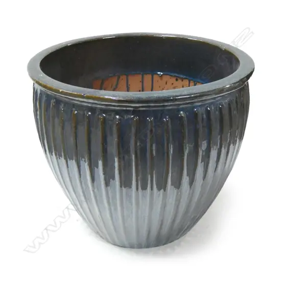 A large teal blue glazed garden pot,