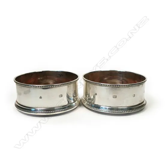 A pair of contemporary silver bottle coasters,