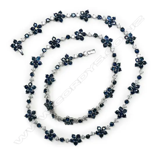 A 14ct white gold, sapphire and diamond floral design necklace,