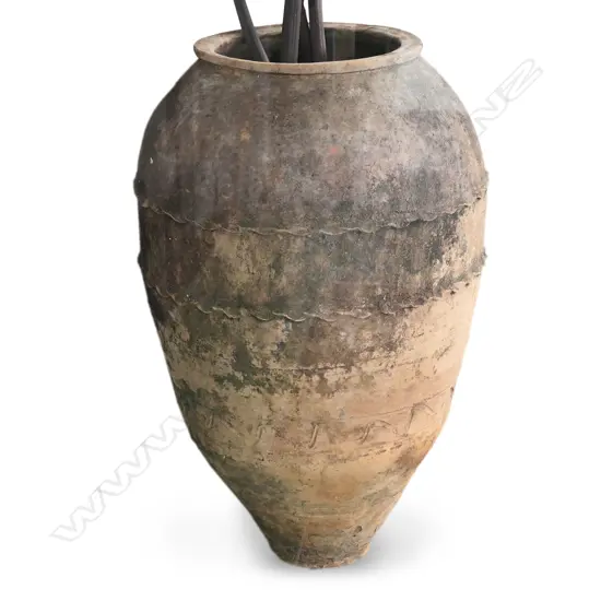 A large old European terracotta olive oil jar,