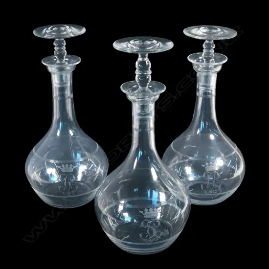 Three early 20thC glass decanters, each etched with a ducal coronet and monogram,