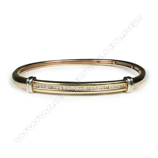 A 9ct yellow gold and channel set diamond hinged bangle,