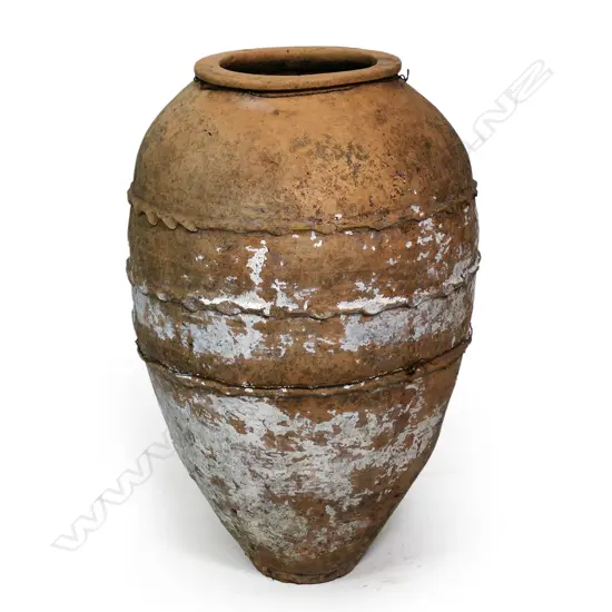 An old European terracotta tall olive oil storage jar,