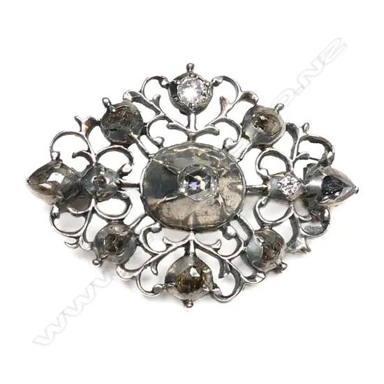 An antique silver and diamond set brooch,