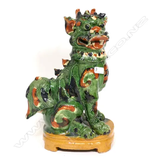A Chinese green and ochre splash glazed pottery figure of a kylin